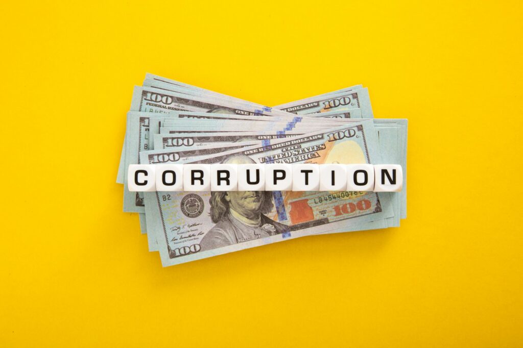 Corruption word with stack of Usd money. Corruption concept