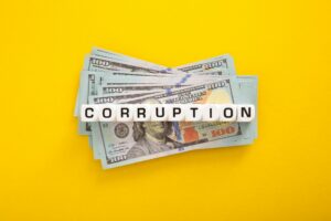 Corruption word with stack of Usd money. Corruption concept
