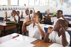 kids showing hands during a lesson at an elementary school ELOI Ministries